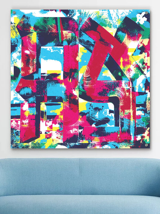 A colorful AHAVA metal wall art print displayed above a light blue sofa.
