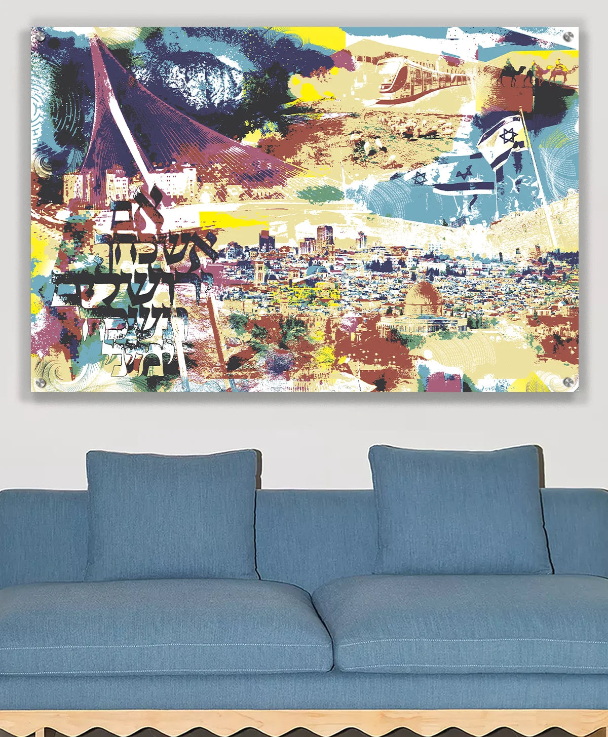 A colorful abstract Jerusalem cityscape wall art print hanging above a blue sofa in a modern living room setting.